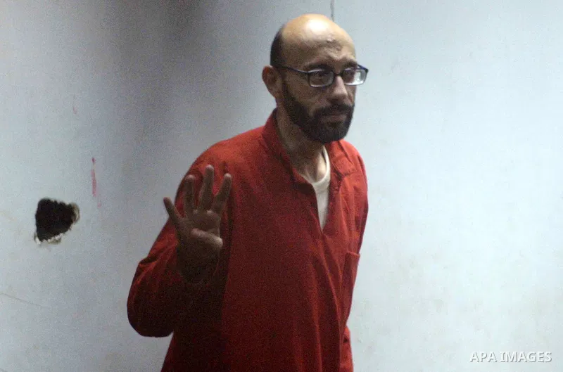 Defendants of Egyptian Muslim Brotherhood sit behind bars during the 'Qatar espionage' case, in a court in Cairo on March 15, 2016. The defendants are accused of 'leaking important national security documents and informa...
