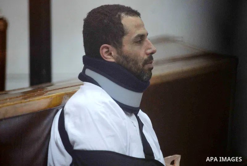 Defendants of Egyptian Muslim Brotherhood sit behind bars during the 'Qatar espionage' case, in a court in Cairo on March 15, 2016. The defendants are accused of 'leaking important national security documents and informa...