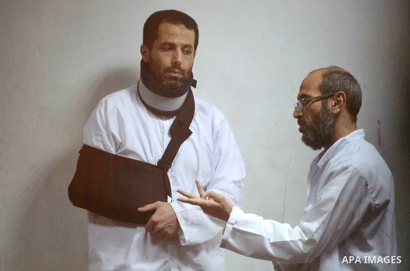 Defendants of Egyptian Muslim Brotherhood sit behind bars during the 'Qatar espionage' case, in a court in Cairo on March 15, 2016. The defendants are accused of 'leaking important national security documents and informa...