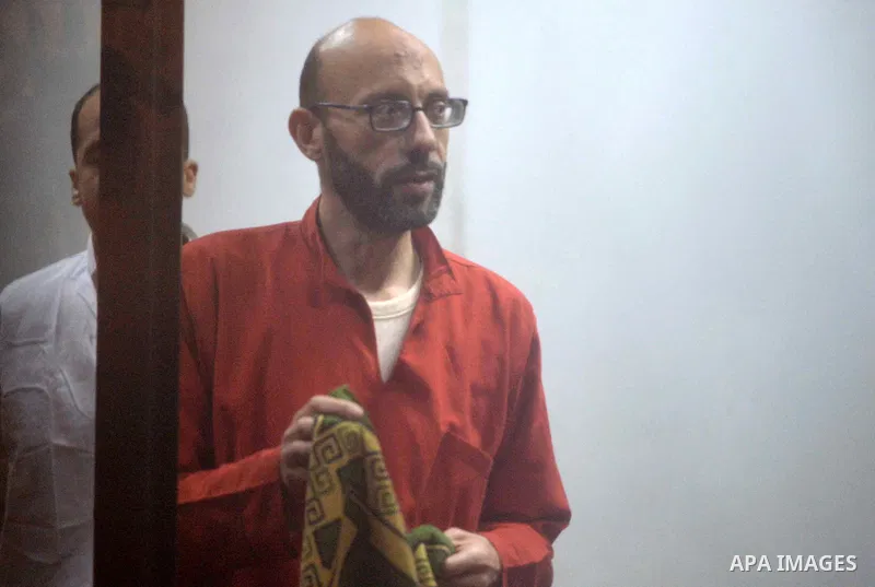 Defendants of Egyptian Muslim Brotherhood sit behind bars during the 'Qatar espionage' case, in a court in Cairo on March 15, 2016. The defendants are accused of 'leaking important national security documents and informa...