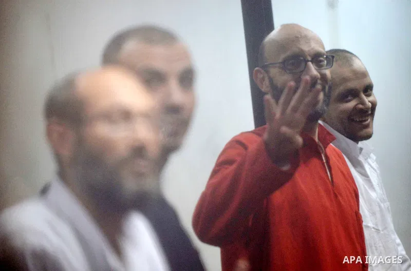 Defendants of Egyptian Muslim Brotherhood sit behind bars during the 'Qatar espionage' case, in a court in Cairo on March 15, 2016. The defendants are accused of 'leaking important national security documents and informa...