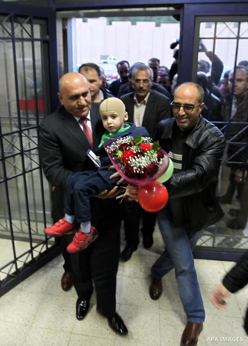 Five-year-old Ahmed Dawabsha, a Palestinian boy who survived a firebombing by Jewish extremists targeting his family home that killed his parents and brother, meets with the governor of the northern Palestinian town of N...