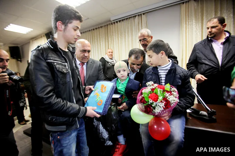 Five-year-old Ahmed Dawabsha, a Palestinian boy who survived a firebombing by Jewish extremists targeting his family home that killed his parents and brother, meets with the governor of the northern Palestinian town of N...