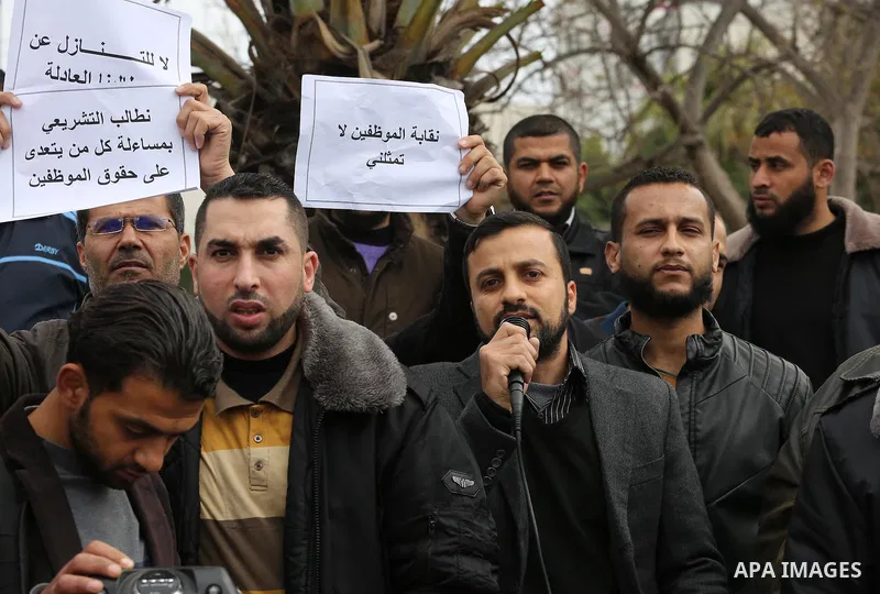 Employees of former Palestinian government take part in a protest to demand for pay their salaries, in Gaza city on March 16, 2016. Photo by Mohammed Asad