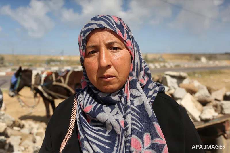 Palestinian woman Jihan Abu Muhsen, who collects bricks for sale from the sites of demolished buildings, poses for a photo in Khan Younis in the southern Gaza Strip March 17, 2016. Abu Muhsen gathers bricks from the site...