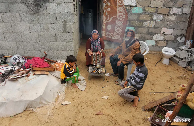 Palestinian woman Jihan Abu Muhsen makes tea before going to work collecting bricks for sale from the sites of demolished buildings, at her dwelling in Khan Younis in the southern Gaza Strip March 17, 2016. Abu Muhsen ga...