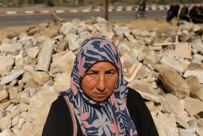 Palestinian woman Jihan Abu Muhsen, who collects bricks for sale from the sites of demolished buildings, poses for a photo in Khan Younis in the southern Gaza Strip March 17, 2016. Abu Muhsen gathers bricks from the site...