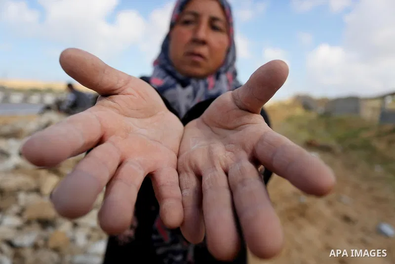 Palestinian woman Jihan Abu Muhsen, who collects bricks for sale from the sites of demolished buildings, poses for a photo in Khan Younis in the southern Gaza Strip March 17, 2016. Abu Muhsen gathers bricks from the site...