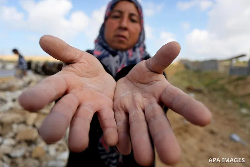 Palestinian woman Jihan Abu Muhsen, who collects bricks for sale from the sites of demolished buildings, poses for a photo in Khan Younis in the southern Gaza Strip March 17, 2016. Abu Muhsen gathers bricks from the site...
