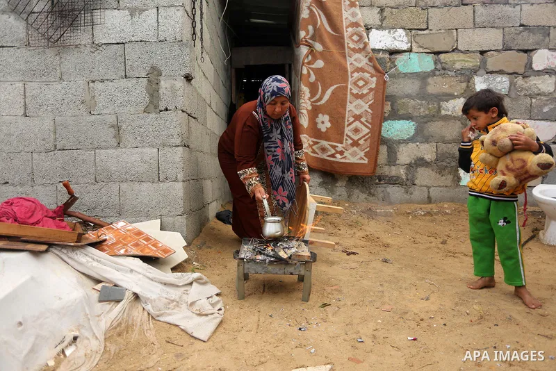 Palestinian woman Jihan Abu Muhsen makes tea before going to work collecting bricks for sale from the sites of demolished buildings, at her dwelling in Khan Younis in the southern Gaza Strip March 17, 2016. Abu Muhsen ga...