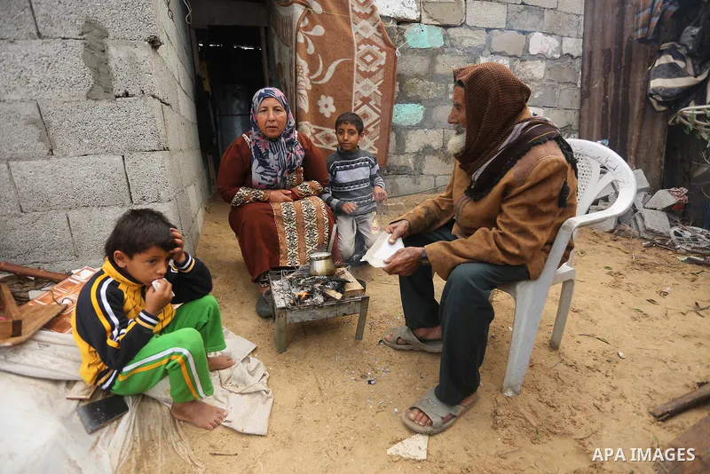 Palestinian woman Jihan Abu Muhsen makes tea before going to work collecting bricks for sale from the sites of demolished buildings, at her dwelling in Khan Younis in the southern Gaza Strip March 17, 2016. Abu Muhsen ga...