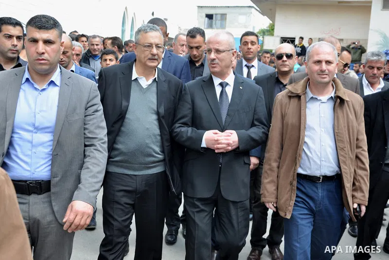 Palestinian Prime Minister Rami Hamdallah attends the funeral of 16 Palestinians, who lost their lives in overturned bus accident in Jordan on their way to Saudi Arabia for umrah in the West Bank village of Deir al-Ghoss...