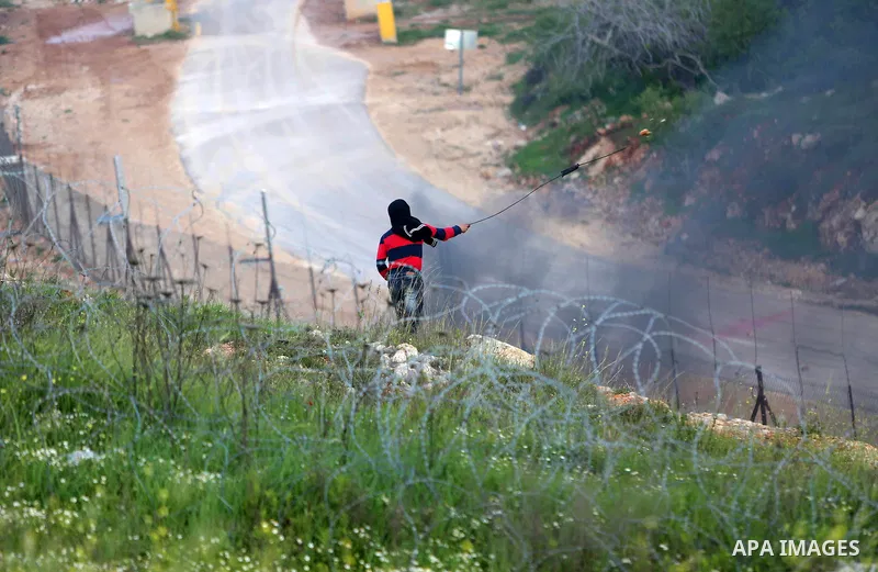 Palestinian protesters clash with Israeli security forces on March 18, 2016, following a demonstration in solidarity with Palestinian prisoners held in Israeli jails, outside the compound of the Israeli-run Ofer prison n...