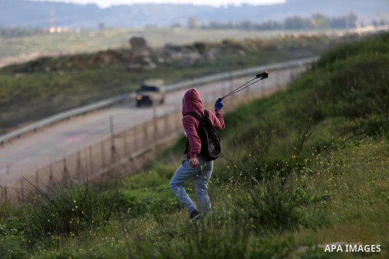 Palestinian protesters clash with Israeli security forces on March 18, 2016, following a demonstration in solidarity with Palestinian prisoners held in Israeli jails, outside the compound of the Israeli-run Ofer prison n...
