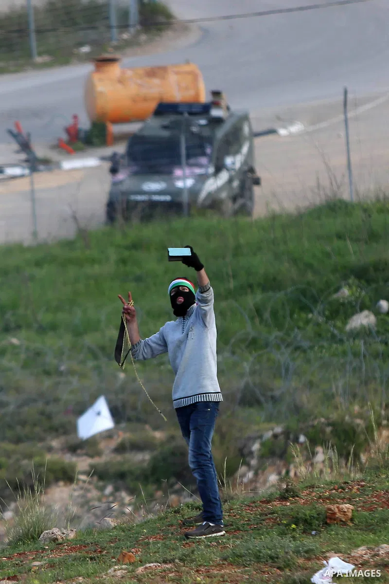 Palestinian protesters clash with Israeli security forces on March 18, 2016, following a demonstration in solidarity with Palestinian prisoners held in Israeli jails, outside the compound of the Israeli-run Ofer prison n...