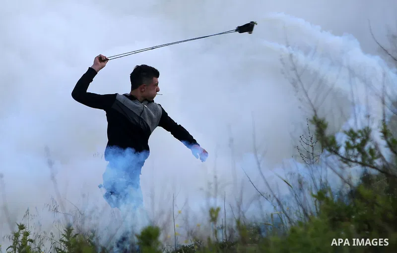 Palestinian protesters clash with Israeli security forces on March 18, 2016, following a demonstration in solidarity with Palestinian prisoners held in Israeli jails, outside the compound of the Israeli-run Ofer prison n...