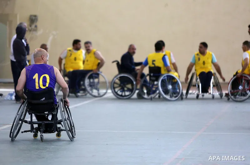 Disabled Palestinians from West Bank and Gaza play a friendly basketball match in the West Bank city of Ramallah on March 18, 2016. Photo by Shadi Hatem