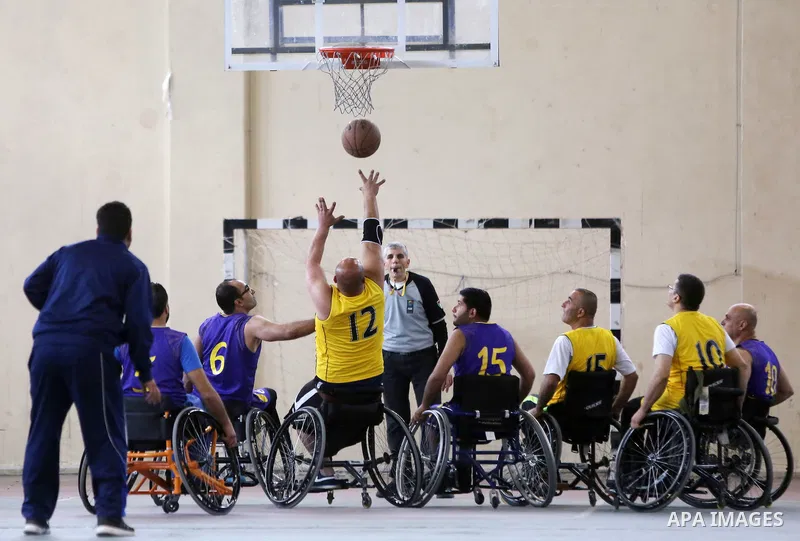 Disabled Palestinians from West Bank and Gaza play a friendly basketball match in the West Bank city of Ramallah on March 18, 2016. Photo by Shadi Hatem