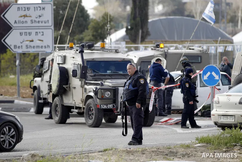 Israeli security forces inspect the scene where a Palestinian, who the Israeli military said tried to stab soldiers, was shot dead at Gush Etzion junction, south of the West Bank city of Bethlehem March 18, 2016. Photo b...