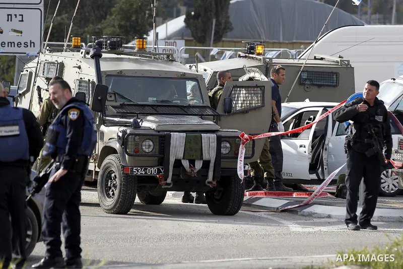 Israeli security forces inspect the scene where a Palestinian, who the Israeli military said tried to stab soldiers, was shot dead at Gush Etzion junction, south of the West Bank city of Bethlehem March 18, 2016. Photo b...