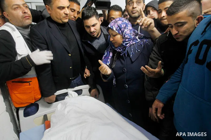 Relatives of Palestinian Mahmoud Abu Fannouneh, 21, who the Israeli military said he tried to stab soldiers, was shot dead at Gush Etzion junction, mourn over his body at a hospital morgue in the West Bank city of Hebron...