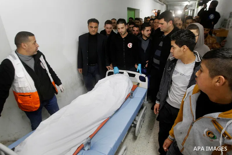 Relatives of Palestinian Mahmoud Abu Fannouneh, 21, who the Israeli military said he tried to stab soldiers, was shot dead at Gush Etzion junction, mourn over his body at a hospital morgue in the West Bank city of Hebron...