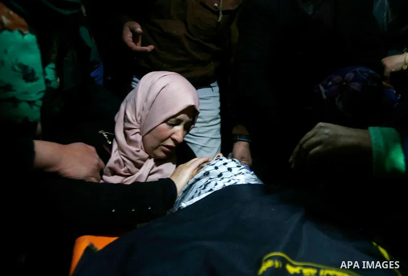 Mother of 19 years old Mahmoud Abu Fanoneh mourns over his body during his funeral in the West Bank city of Hebron, 19 March 2016. Mahmoud who according to the Israeli Army attempted to kill an Israeli soldier at a main...