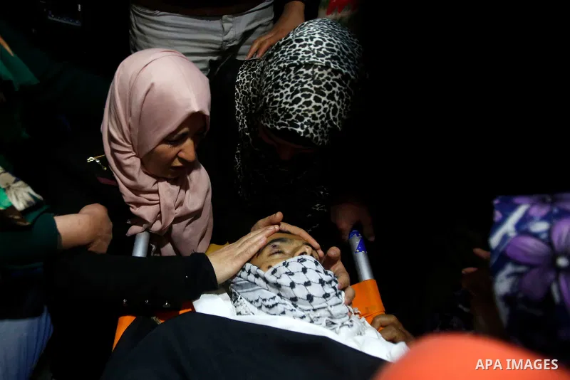 Mother of 19 years old Mahmoud Abu Fanoneh mourns over his body during his funeral in the West Bank city of Hebron, 19 March 2016. Mahmoud who according to the Israeli Army attempted to kill an Israeli soldier at a main...