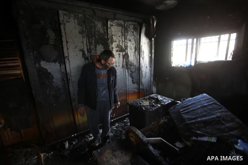 A Palestinian man inspects the damage to the torched house of Ibrahim Dawabsheh, the main witness in the July arson attack that killed a Palestinian family, in the Israeli occupied West Bank village of Duma near Nablus ,...