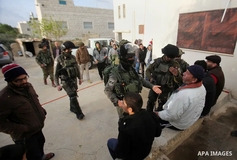 Israeli security forces stand guard outside a Palestinian burnt-out house belonging to a key witness to an arson attack which took place last year by Jewish extremists that killed a Palestinian family, in the Israeli occ...