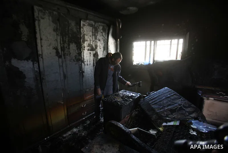 A Palestinian man inspects the damage to the torched house of Ibrahim Dawabsheh, the main witness in the July arson attack that killed a Palestinian family, in the Israeli occupied West Bank village of Duma near Nablus ,...