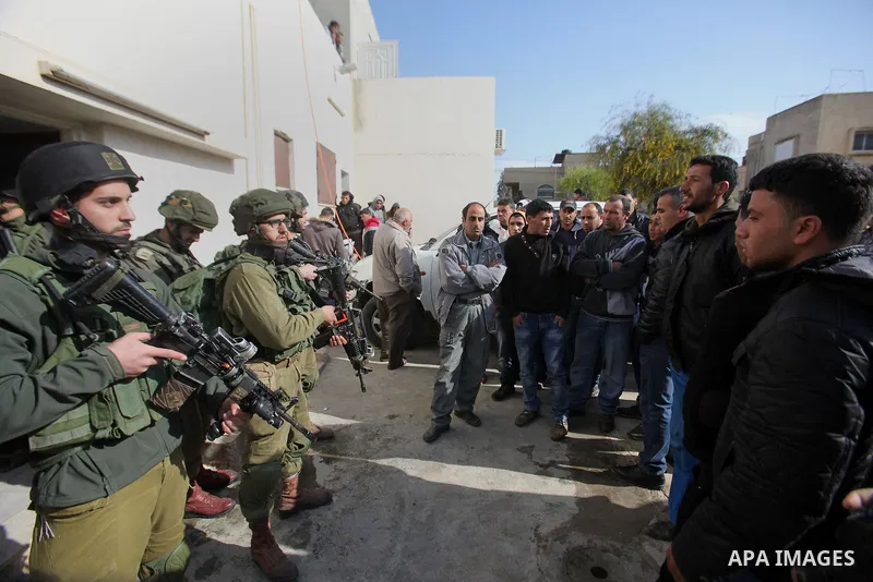 Israeli security forces stand guard outside a Palestinian burnt-out house belonging to a key witness to an arson attack which took place last year by Jewish extremists that killed a Palestinian family, in the Israeli occ...