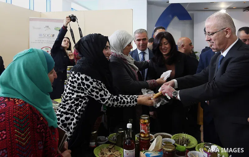 Palestinian Prime Minister Rami Hamdallah attends the opening of Palestinian food exhibition in the West Bank city of Ramallah on March 20, 2016. Photo by Prime Minister Office