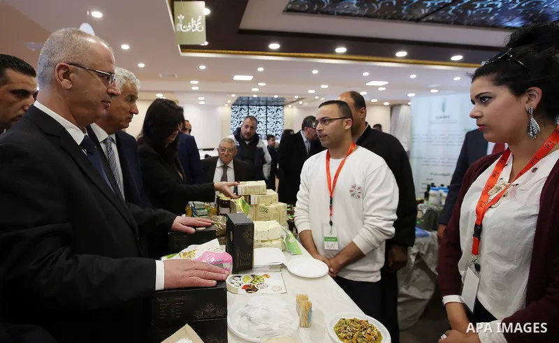 Palestinian Prime Minister Rami Hamdallah attends the opening of Palestinian food exhibition in the West Bank city of Ramallah on March 20, 2016. Photo by Prime Minister Office