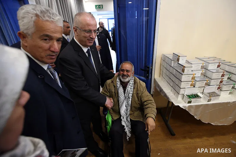 Palestinian Prime Minister Rami Hamdallah attends the opening of Palestinian food exhibition in the West Bank city of Ramallah on March 20, 2016. Photo by Prime Minister Office