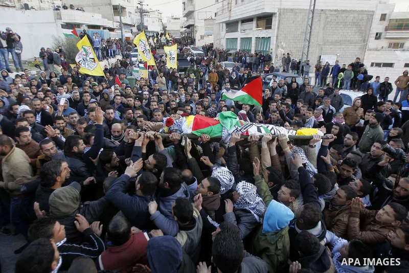 Mourners carry the body of Palestinian Ali Taqatqa, who the Israeli military said was shot dead with another Palestinian by Israeli troops after they stabbed and wounded an Israeli soldier on Thursday outside a Jewish se...