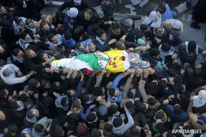 Mourners carry the body of Palestinian Ali Taqatqa, who the Israeli military said was shot dead with another Palestinian by Israeli troops after they stabbed and wounded an Israeli soldier on Thursday outside a Jewish se...