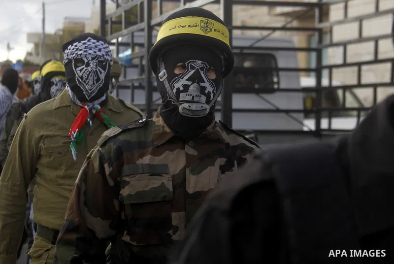Masked Palestinians march during the funeral of Ali Taqatqa and Ali Thawabteh, who the Israeli military said were shot dead by Israeli troops after they stabbed and wounded an Israeli soldier on Thursday outside a Jewish...