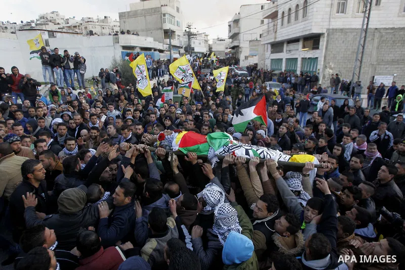 Mourners carry the body of Palestinian Ali Taqatqa, who the Israeli military said was shot dead with another Palestinian by Israeli troops after they stabbed and wounded an Israeli soldier on Thursday outside a Jewish se...