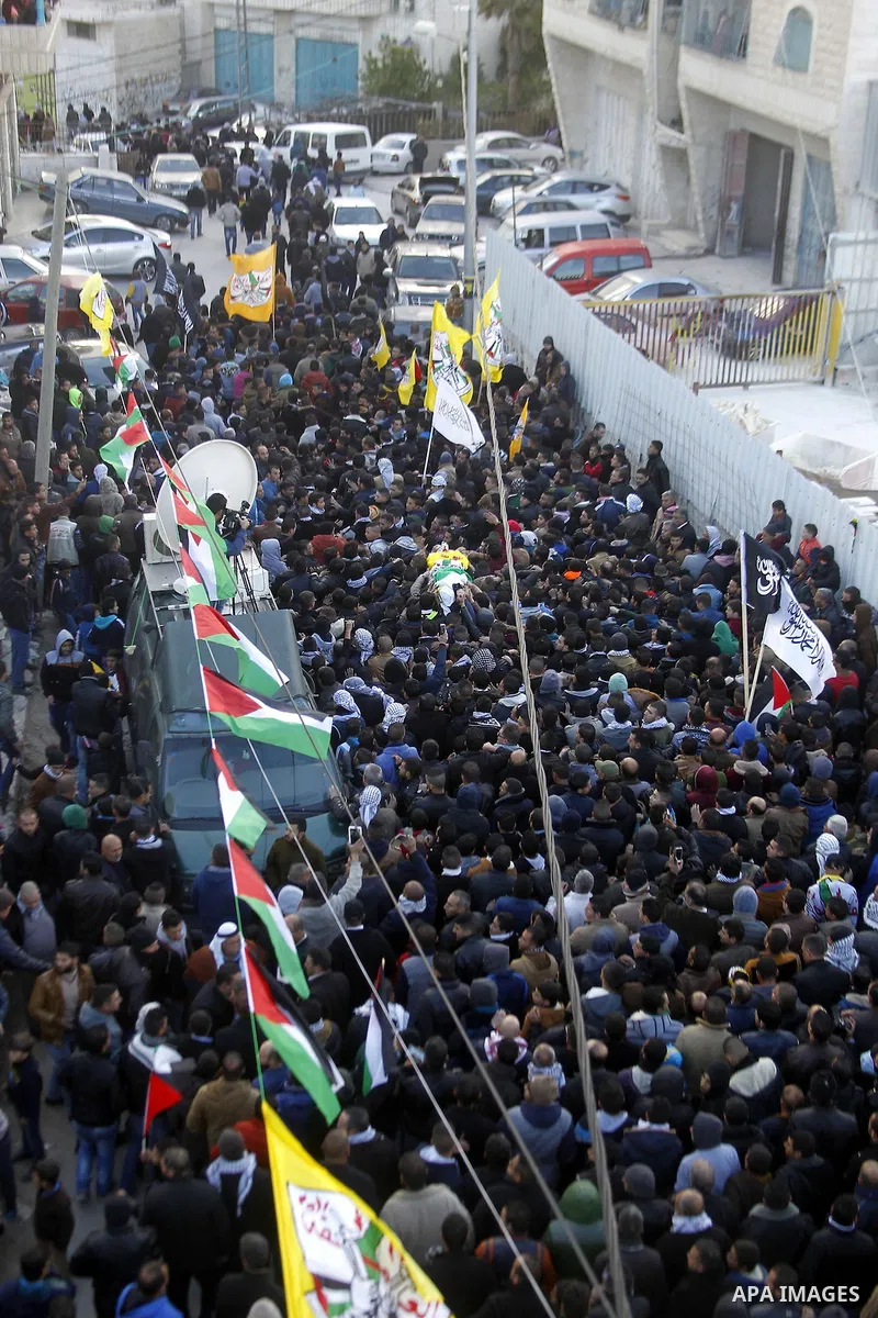 Mourners carry the body of Palestinian Ali Taqatqa, who the Israeli military said was shot dead with another Palestinian by Israeli troops after they stabbed and wounded an Israeli soldier on Thursday outside a Jewish se...