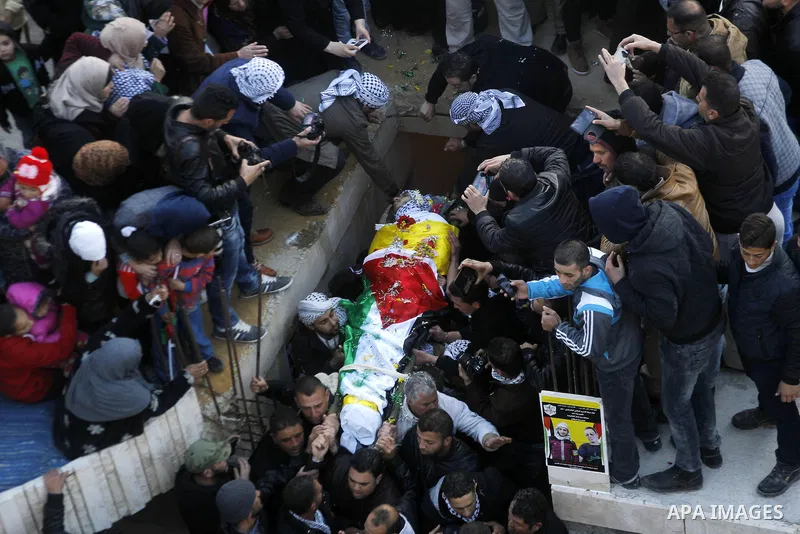 Mourners carry the body of Palestinian Ali Taqatqa, who the Israeli military said was shot dead with another Palestinian by Israeli troops after they stabbed and wounded an Israeli soldier on Thursday outside a Jewish se...