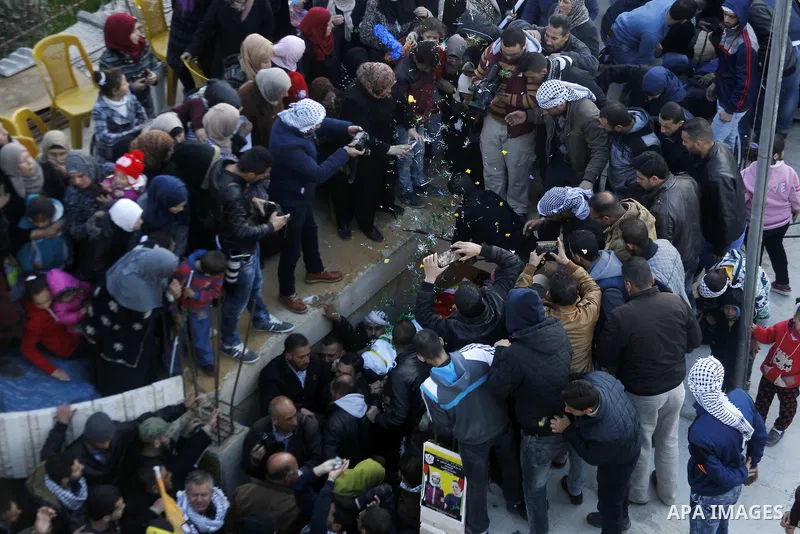 Mourners carry the body of Palestinian Ali Taqatqa, who the Israeli military said was shot dead with another Palestinian by Israeli troops after they stabbed and wounded an Israeli soldier on Thursday outside a Jewish se...