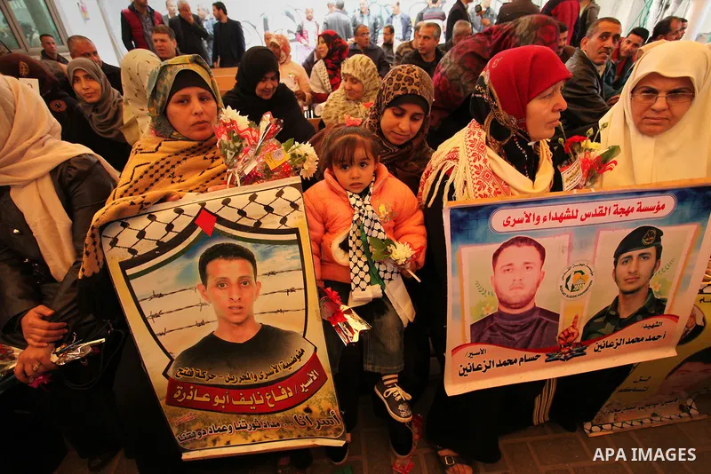 Palestinian women take part in a protest demanding release the prisoners in Israeli jails, in front of Red cross office, in Gaza city, on March 21, 2016. Photo by Ashraf Amra
