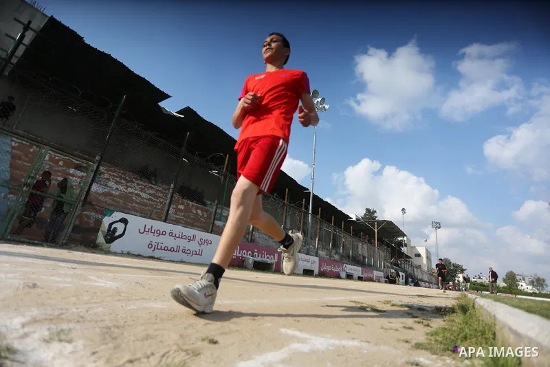 Palestinian youths take part in a local running championship at Yarmouk Stadium in Gaza city on March 21, 2016. Photo by Mohammed Asad