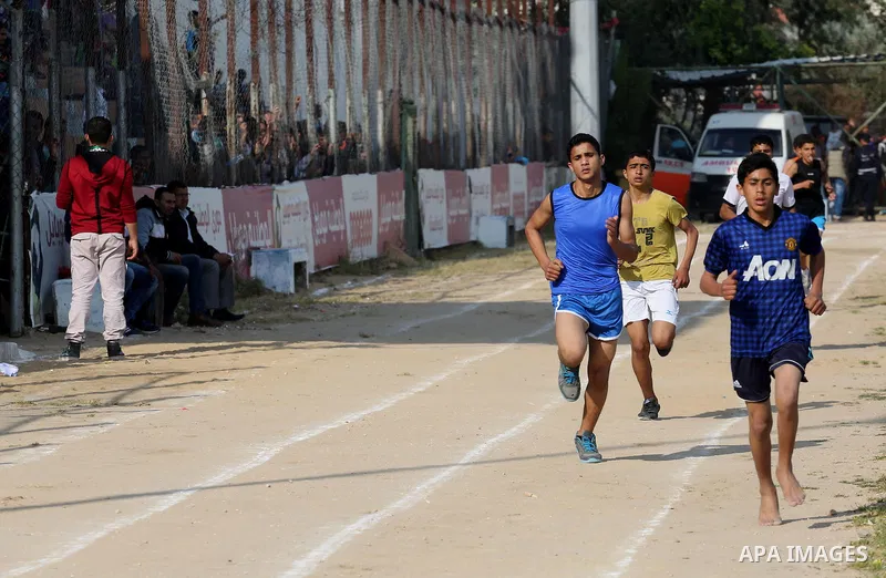 Palestinian youths take part in a local running championship at Yarmouk Stadium in Gaza city on March 21, 2016. Photo by Mohammed Asad