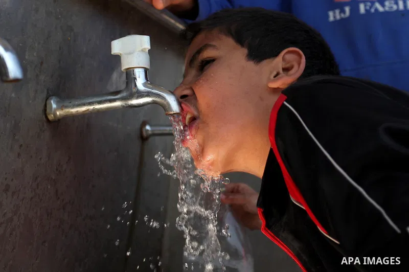 A Palestinian boy drinks a water from a public tap marking the Water World Day in Beit Lahia in the northern Gaza Strip, on March 22, 2016. Photo by Ashraf Amra