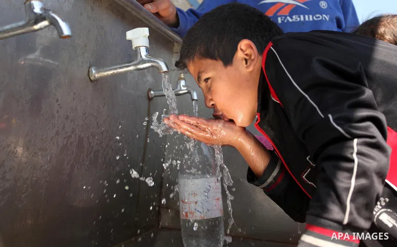 A Palestinian boy drinks a water from a public tap marking the Water World Day in Beit Lahia in the northern Gaza Strip, on March 22, 2016. Photo by Ashraf Amra