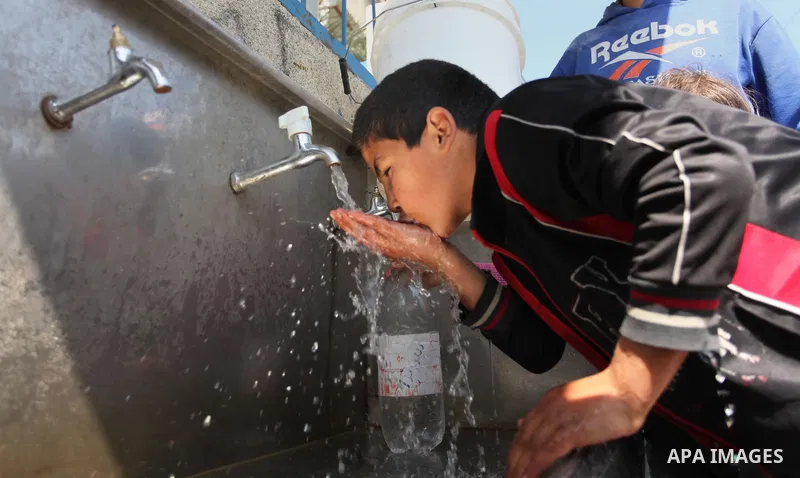 A Palestinian boy drinks a water from a public tap marking the Water World Day in Beit Lahia in the northern Gaza Strip, on March 22, 2016. Photo by Ashraf Amra