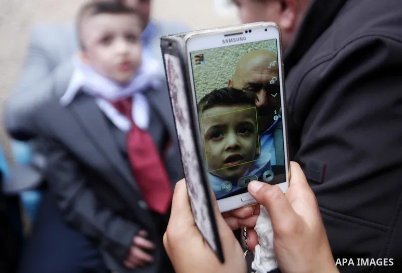 Palestinian boy Ahmed Dawabsha, 5, who suffered severe burns in an arson attack by suspected Jewish attackers on his family home last July and in which his younger brother, Ali, and his parents both died, is welcomed by...