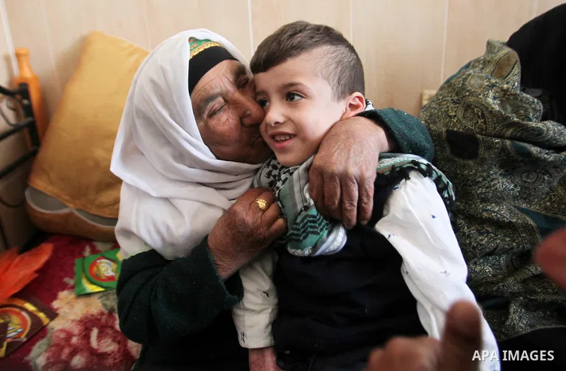 Palestinian boy Ahmed Dawabsha, 5, who suffered severe burns in an arson attack by suspected Jewish attackers on his family home last July and in which his younger brother, Ali, and his parents both died, is welcomed by...
